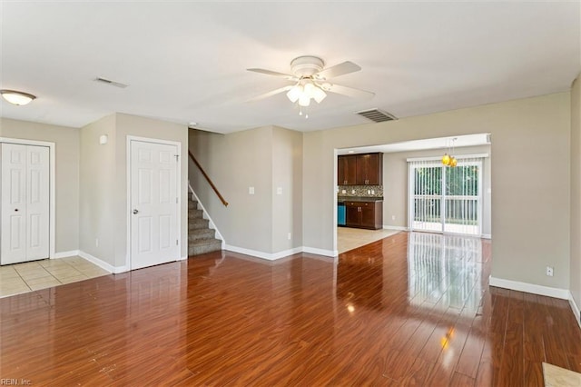 305 Roane Dr, Hampton, VA 23669 - unfurnished living room featuring a ceiling fan, stairway, and wood finished floors