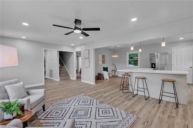 1226 Penniman Rd, Williamsburg, VA 23185 - living room with light wood-type flooring, stairs, a ceiling fan, and recessed lighting