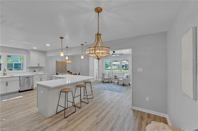 1226 Penniman Rd, Williamsburg, VA 23185 - kitchen with dishwasher, a breakfast bar area, healthy amount of natural light, and a center island