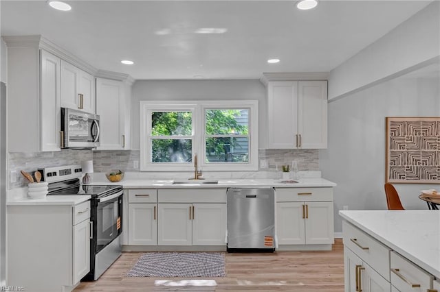 1226 Penniman Rd, Williamsburg, VA 23185 - kitchen with stainless steel appliances, white cabinets, tasteful backsplash, light wood-style floors, and recessed lighting