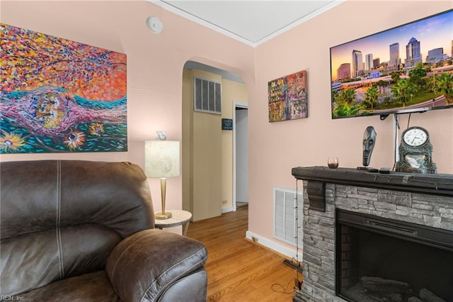 8048 Tidewater Dr, Norfolk, VA 23505 - living area with wood finished floors, arched walkways, crown molding, and a fireplace