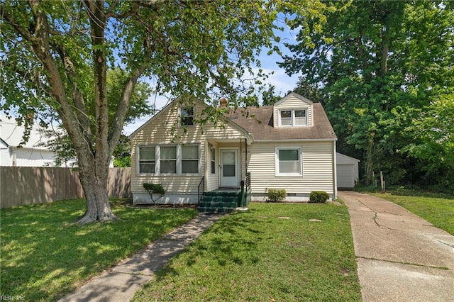 8048 Tidewater Dr, Norfolk, VA 23505 - cape cod house featuring an outbuilding, a garage, and a chimney