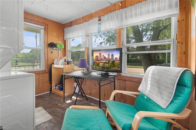 8048 Tidewater Dr, Norfolk, VA 23505 - sunroom with estacked washer and dryer, wooden walls, and concrete floors