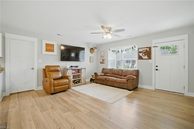 116 B St, Moyock, NC 27958 - living area with a ceiling fan and light wood-style flooring