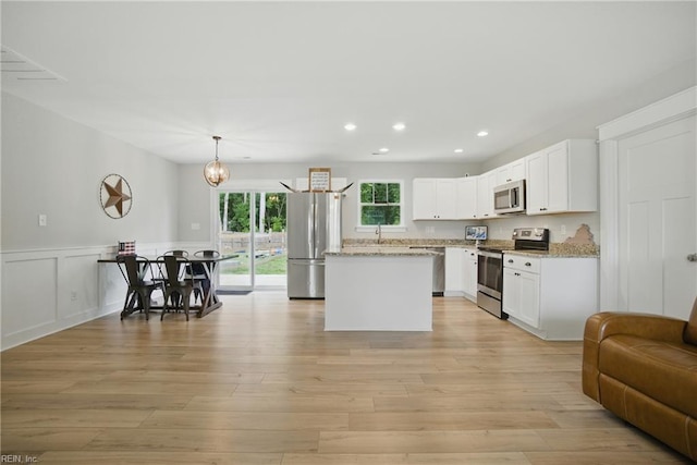 116 B St, Moyock, NC 27958 - kitchen with stainless steel appliances, a center island, white cabinets, open floor plan, and recessed lighting