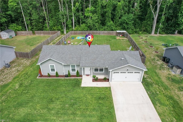 116 B St, Moyock, NC 27958 - ranch-style house with concrete driveway, an attached garage, roof with shingles, a shed, and a fenced backyard
