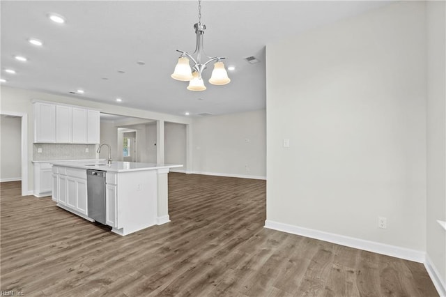 156 Quarter Horse Loop, Hertford, NC 27944 - kitchen with stainless steel dishwasher, a chandelier, white cabinets, wood finished floors, and a center island with sink