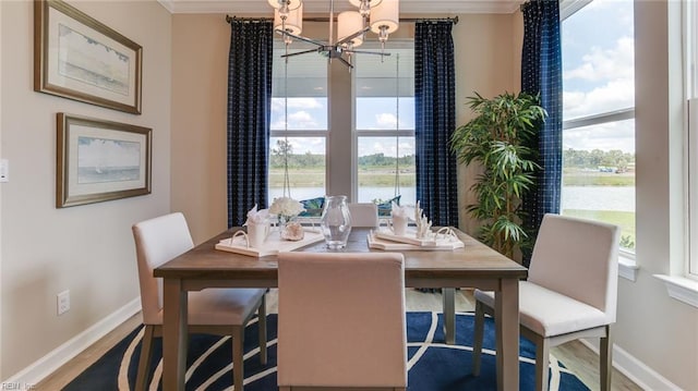 156 Quarter Horse Loop, Hertford, NC 27944 - dining room with a chandelier, ornamental molding, healthy amount of natural light, a water view, and wood finished floors