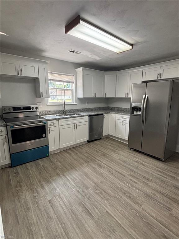 219 Gale Ave, Chesapeake, VA 23323 - kitchen featuring stainless steel appliances, wood finished floors, and white cabinets