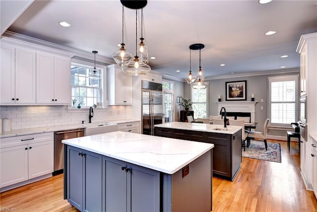 1808 John Hancock Rd, Williamsburg, VA 23185 - kitchen featuring appliances with stainless steel finishes, a center island, plenty of natural light, tasteful backsplash, and ornamental molding