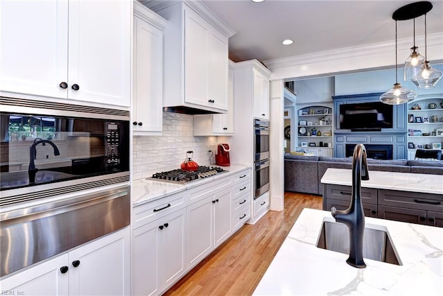 1808 John Hancock Rd, Williamsburg, VA 23185 - kitchen featuring appliances with stainless steel finishes, open floor plan, white cabinetry, a warming drawer, and light wood-style flooring