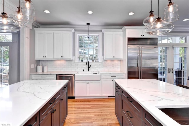 1808 John Hancock Rd, Williamsburg, VA 23185 - kitchen featuring appliances with stainless steel finishes, white cabinetry, french doors, healthy amount of natural light, and recessed lighting