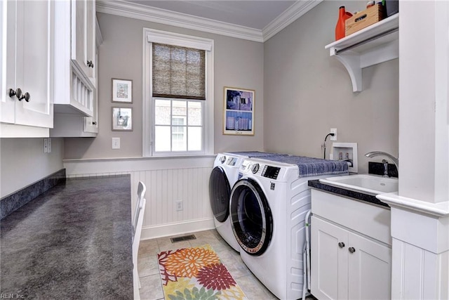 1808 John Hancock Rd, Williamsburg, VA 23185 - laundry area featuring washer and clothes dryer, crown molding, cabinet space, a wainscoted wall, and light tile patterned floors