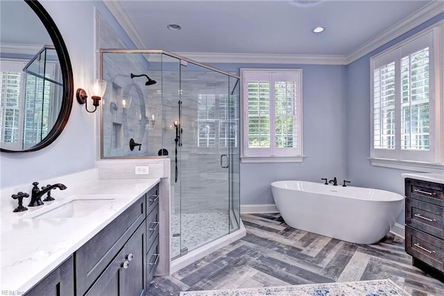 1808 John Hancock Rd, Williamsburg, VA 23185 - bathroom featuring vanity, healthy amount of natural light, a freestanding bath, ornamental molding, and recessed lighting