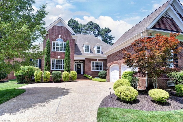 1808 John Hancock Rd, Williamsburg, VA 23185 - traditional-style home featuring brick siding, driveway, a garage, and roof with shingles