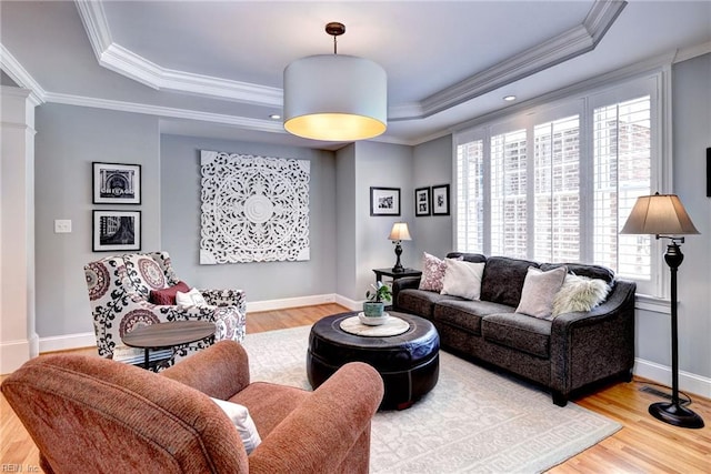 1808 John Hancock Rd, Williamsburg, VA 23185 - living area featuring a tray ceiling, wood finished floors, crown molding, and decorative columns
