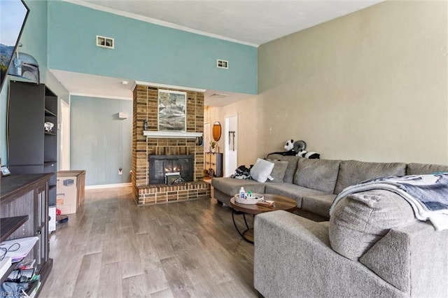 1408 Planting Ct, Virginia Beach, VA 23453 - living room with wood finished floors, a fireplace, crown molding, and a towering ceiling