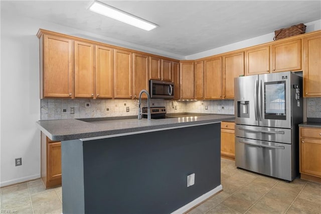 1028 Cathedral Dr, Suffolk, VA 23434 - kitchen featuring stainless steel appliances, dark countertops, decorative backsplash, a center island with sink, and light tile patterned floors