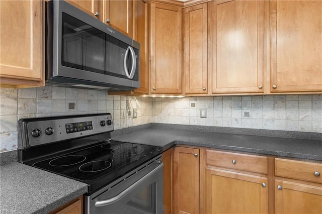 1028 Cathedral Dr, Suffolk, VA 23434 - kitchen with appliances with stainless steel finishes, dark countertops, backsplash, and brown cabinets