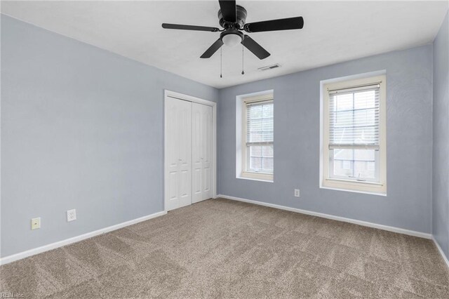 1028 Cathedral Dr, Suffolk, VA 23434 - unfurnished bedroom featuring carpet, a closet, and a ceiling fan