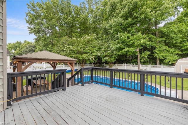 1028 Cathedral Dr, Suffolk, VA 23434 - deck with a gazebo, a fenced backyard, a storage unit, and view of wooded area