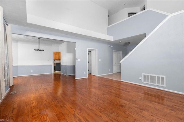 1028 Cathedral Dr, Suffolk, VA 23434 - unfurnished living room with wood finished floors, a high ceiling, and a chandelier