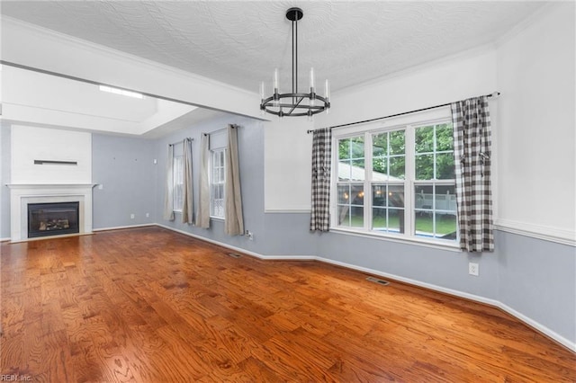 1028 Cathedral Dr, Suffolk, VA 23434 - unfurnished living room with a chandelier, wood finished floors, a fireplace, and ornamental molding