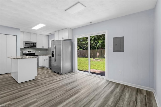 1833 Darville Dr, Hampton, VA 23663 - kitchen featuring appliances with stainless steel finishes, electric panel, light wood-type flooring, tasteful backsplash, and white cabinetry
