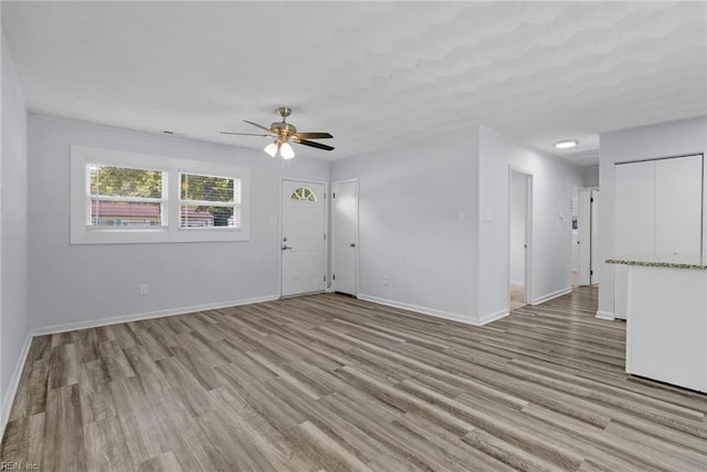 1833 Darville Dr, Hampton, VA 23663 - unfurnished living room featuring a ceiling fan and light wood-style flooring