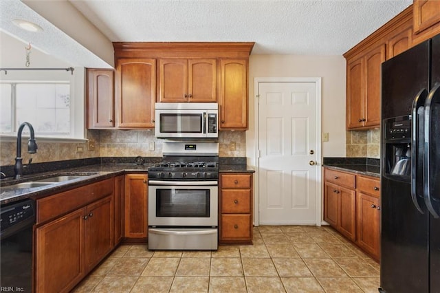 208 Sherbrooke Dr, Newport News, VA 23602 - kitchen with black appliances, a textured ceiling, and brown cabinetry