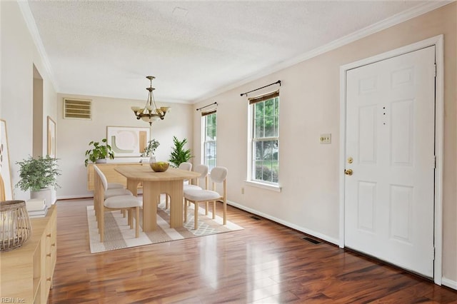 208 Sherbrooke Dr, Newport News, VA 23602 - dining space featuring ornamental molding, wood finished floors, a chandelier, and a textured ceiling