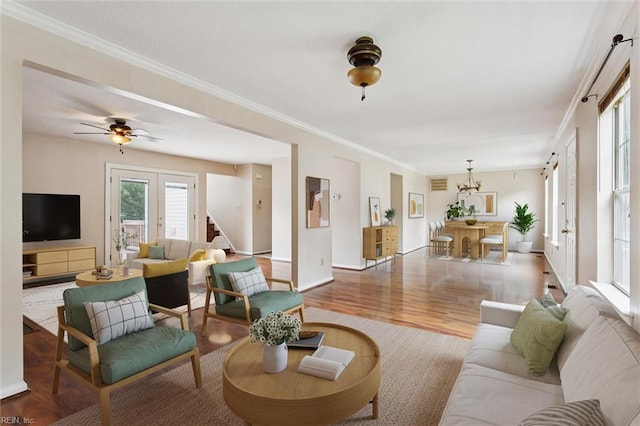 208 Sherbrooke Dr, Newport News, VA 23602 - living room featuring wood finished floors, crown molding, a chandelier, stairway, and a ceiling fan