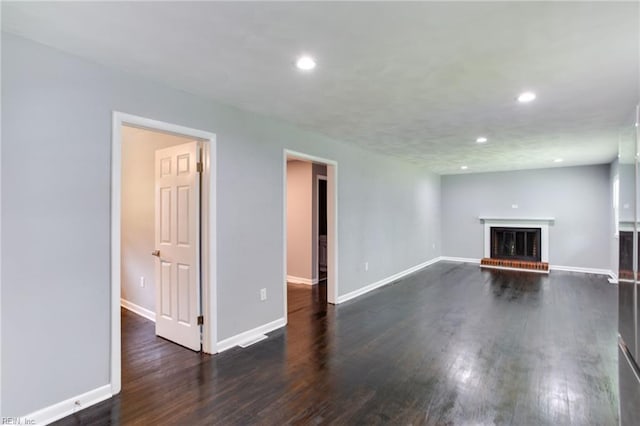 194 Railroad St, Williamsburg, VA 23185 - unfurnished living room with a brick fireplace, recessed lighting, and dark wood-style flooring