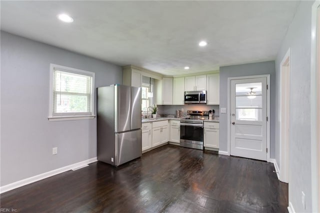 194 Railroad St, Williamsburg, VA 23185 - kitchen with appliances with stainless steel finishes, dark wood-style floors, recessed lighting, a ceiling fan, and white cabinets