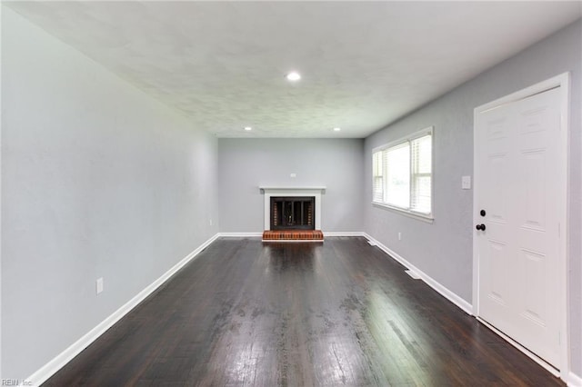 194 Railroad St, Williamsburg, VA 23185 - unfurnished living room with a brick fireplace, dark wood-type flooring, and recessed lighting