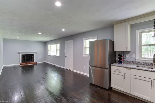 194 Railroad St, Williamsburg, VA 23185 - kitchen with freestanding refrigerator, light stone countertops, a fireplace, dark wood finished floors, and recessed lighting
