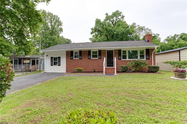 194 Railroad St, Williamsburg, VA 23185 - ranch-style house with a chimney, a front lawn, driveway, brick siding, and entry steps