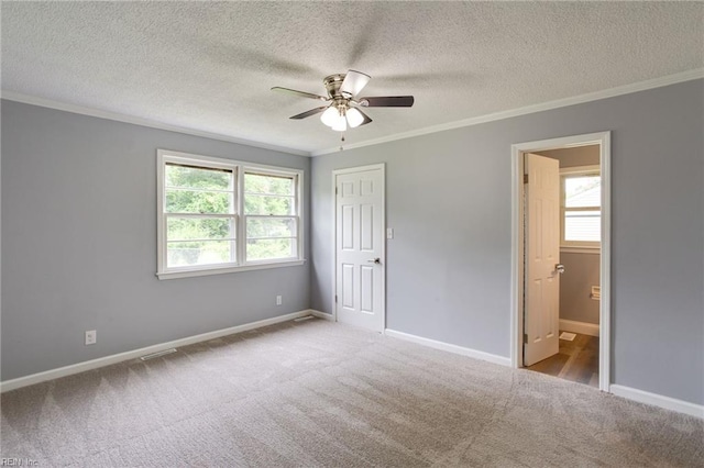 194 Railroad St, Williamsburg, VA 23185 - unfurnished bedroom featuring crown molding, carpet floors, multiple windows, a textured ceiling, and ceiling fan