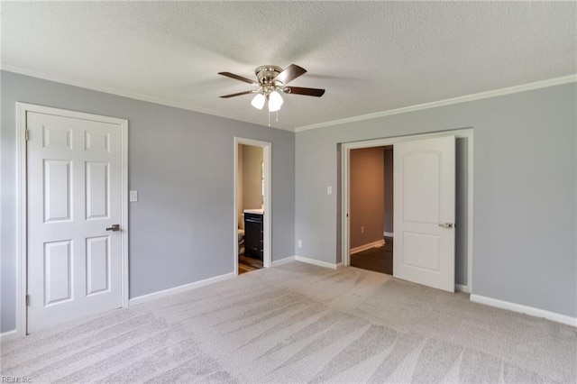 194 Railroad St, Williamsburg, VA 23185 - unfurnished bedroom with carpet floors, ornamental molding, a textured ceiling, connected bathroom, and a ceiling fan
