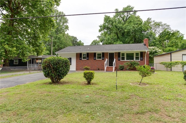 194 Railroad St, Williamsburg, VA 23185 - single story home featuring brick siding, a chimney, a front lawn, and asphalt driveway