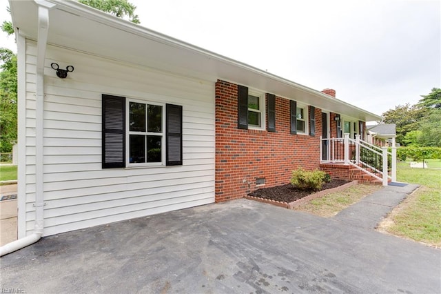 194 Railroad St, Williamsburg, VA 23185 - view of front of house with brick siding, crawl space, and a patio area