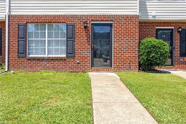 48 Terri Sue Ct, Hampton, VA 23666 - doorway to property with a lawn and brick siding