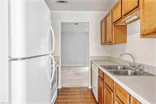 48 Terri Sue Ct, Hampton, VA 23666 - kitchen featuring white appliances, light countertops, brown cabinetry, light wood-type flooring, and light colored carpet