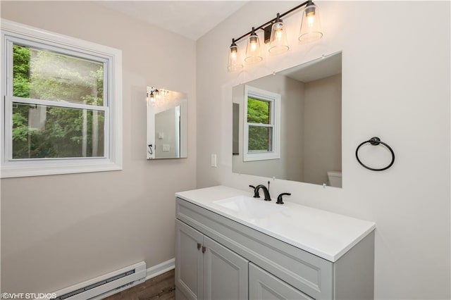 105 Fairfield Ave, Suffolk, VA 23434 - bathroom featuring baseboard heating, vanity, and wood finished floors