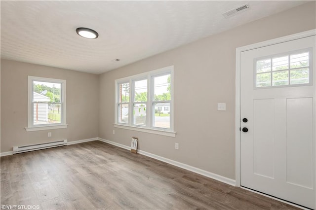 105 Fairfield Ave, Suffolk, VA 23434 - foyer featuring baseboard heating, plenty of natural light, and wood finished floors