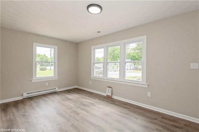 105 Fairfield Ave, Suffolk, VA 23434 - empty room featuring a baseboard radiator, plenty of natural light, and wood finished floors