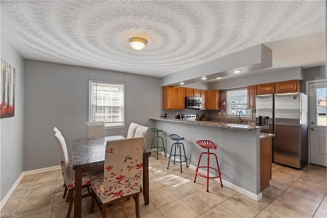 7425 Evelyn T Butts Ave, Norfolk, VA 23513 - dining space with plenty of natural light and light tile patterned floors
