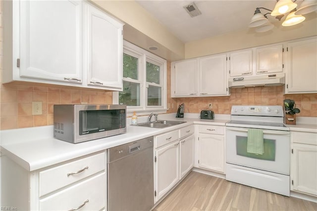 2405 Broadnax Cir, Chesapeake, VA 23323 - kitchen featuring stainless steel appliances, under cabinet range hood, white cabinets, and backsplash