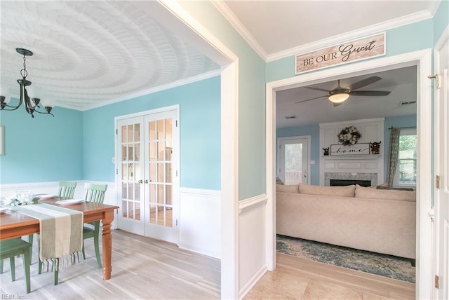 2405 Broadnax Cir, Chesapeake, VA 23323 - dining space featuring french doors, crown molding, a chandelier, wainscoting, and a ceiling fan
