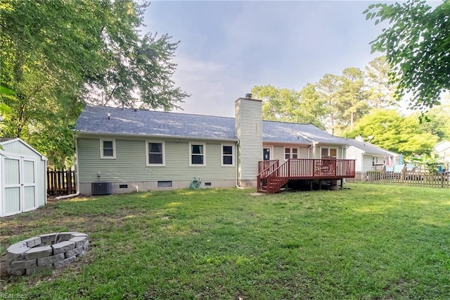 2405 Broadnax Cir, Chesapeake, VA 23323 - back of property featuring a deck, a fenced backyard, a shed, a chimney, and an outdoor fire pit